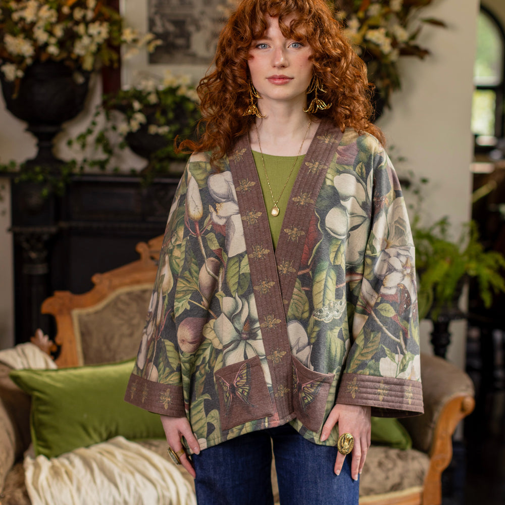 
                  
                    Model wearing a cozy cardigan lined with fleece featuring vintage magnolia lithographs, delicate moth etchings, and charming bumblebee trim - Market of stars
                  
                