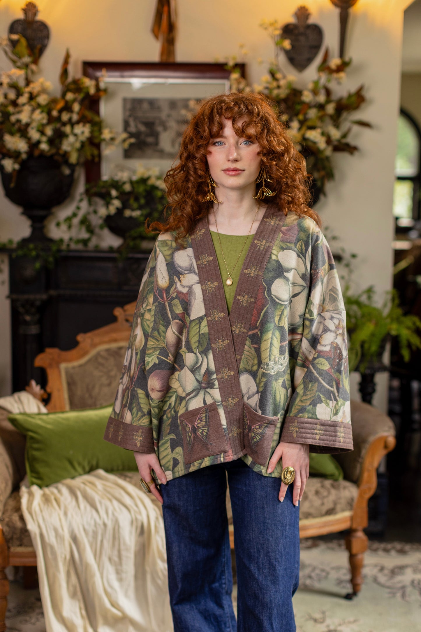 Model wearing a cozy cardigan lined with fleece featuring vintage magnolia lithographs, delicate moth etchings, and charming bumblebee trim - Market of stars