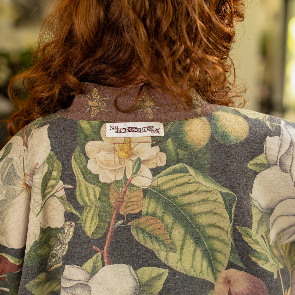 
                  
                    Model wearing a cozy cardigan lined with fleece featuring vintage magnolia lithographs, delicate moth etchings, and charming bumblebee trim - Market of stars
                  
                