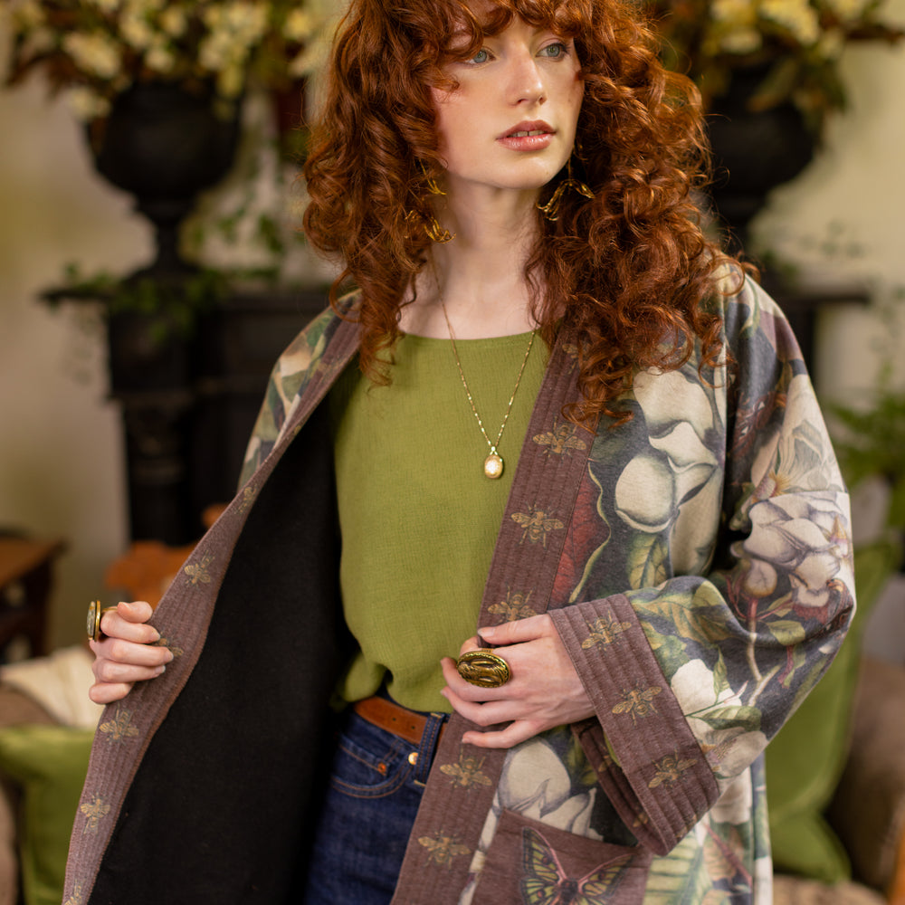 
                  
                    Model wearing a cozy cardigan lined with fleece featuring vintage magnolia lithographs, delicate moth etchings, and charming bumblebee trim - Market of stars
                  
                