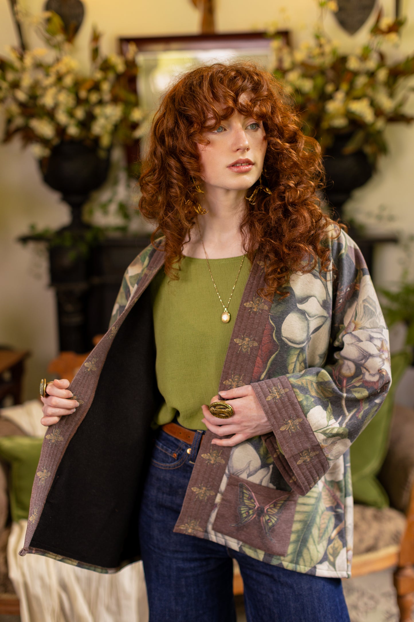 Model wearing a cozy cardigan lined with fleece featuring vintage magnolia lithographs, delicate moth etchings, and charming bumblebee trim - Market of stars