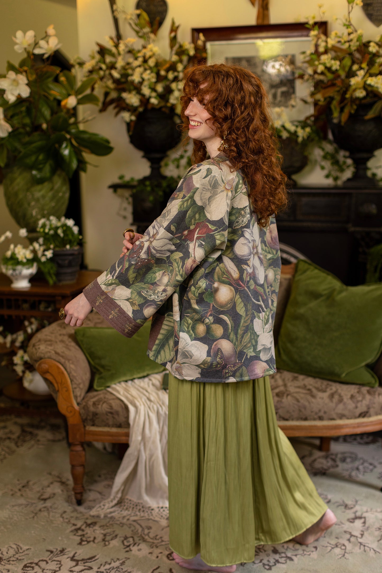 Model wearing a cozy cardigan lined with fleece featuring vintage magnolia lithographs, delicate moth etchings, and charming bumblebee trim - Market of stars