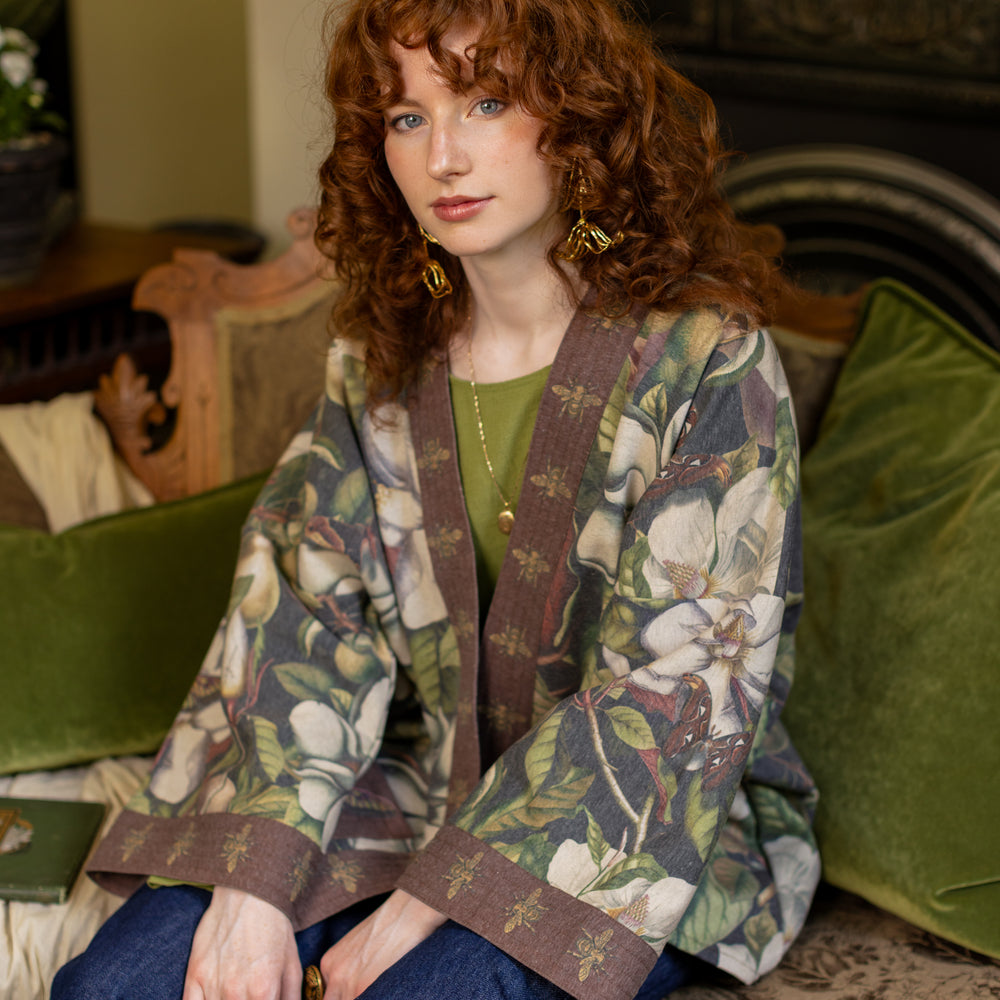 
                  
                    Model wearing a cozy cardigan lined with fleece featuring vintage magnolia lithographs, delicate moth etchings, and charming bumblebee trim - Market of stars
                  
                