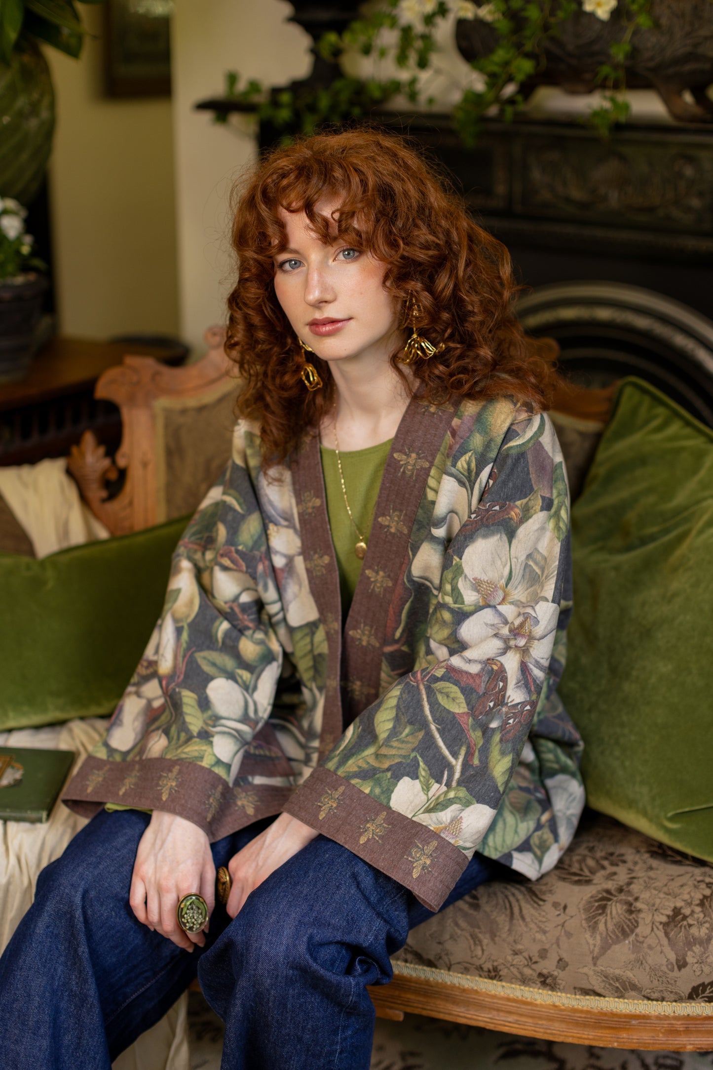 Model wearing a cozy cardigan lined with fleece featuring vintage magnolia lithographs, delicate moth etchings, and charming bumblebee trim - Market of stars