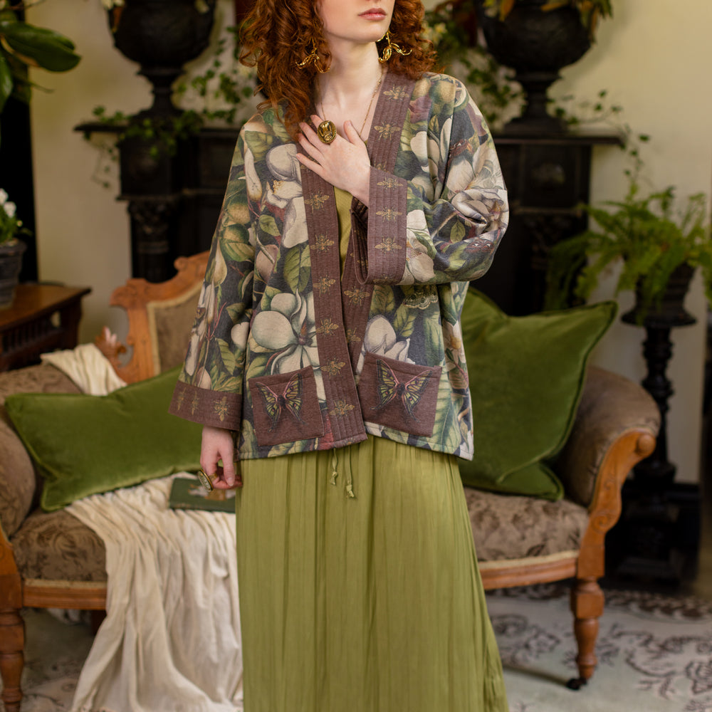 
                  
                    Model wearing a cozy cardigan lined with fleece featuring vintage magnolia lithographs, delicate moth etchings, and charming bumblebee trim - Market of stars
                  
                