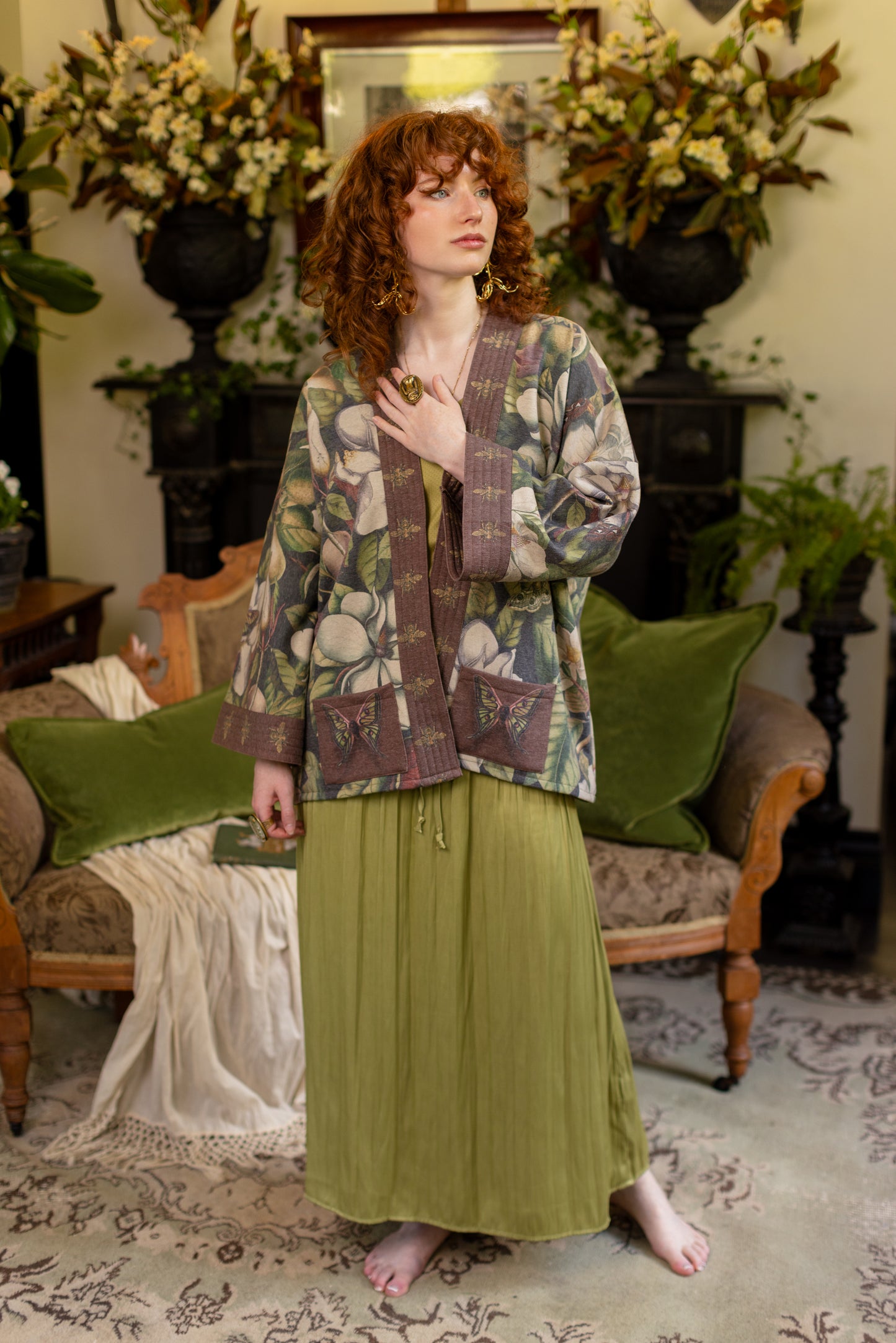 Model wearing a cozy cardigan lined with fleece featuring vintage magnolia lithographs, delicate moth etchings, and charming bumblebee trim - Market of stars