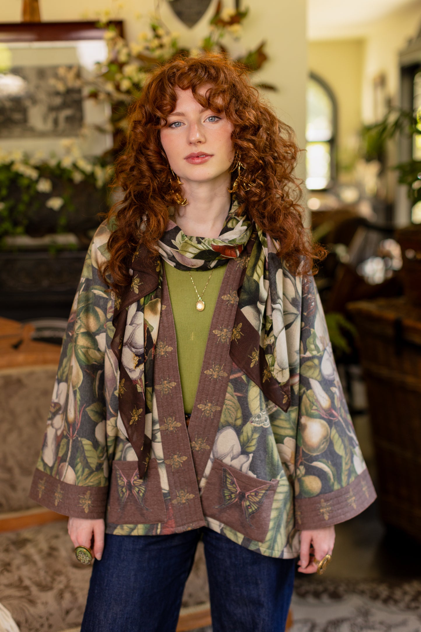 Model wearing a cozy cardigan lined with fleece featuring vintage magnolia lithographs, delicate moth etchings, and charming bumblebee trim - Market of stars