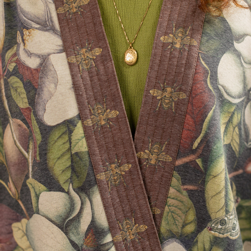 
                  
                    Model wearing a cozy cardigan lined with fleece featuring vintage magnolia lithographs, delicate moth etchings, and charming bumblebee trim - Market of stars
                  
                
