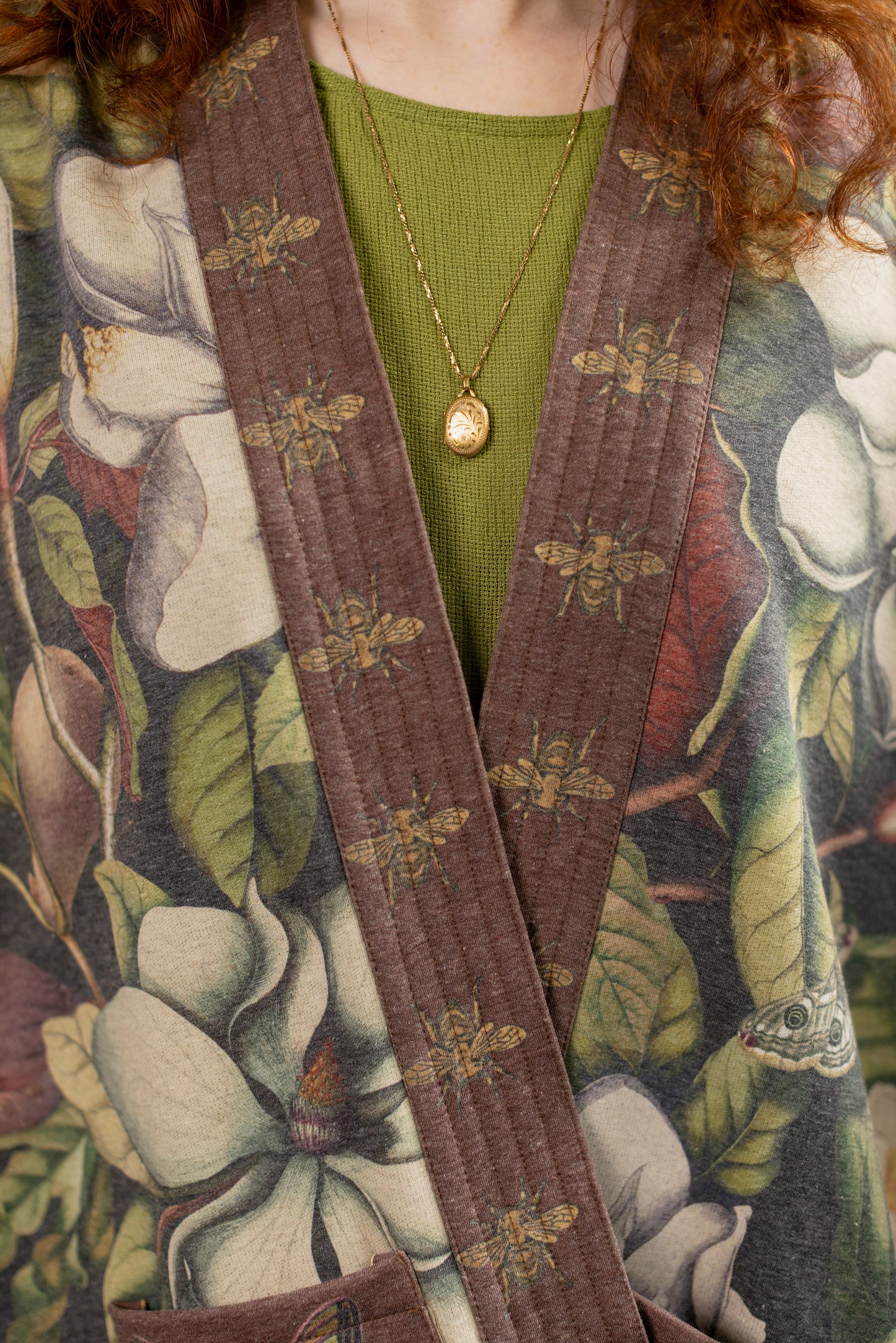 Model wearing a cozy cardigan lined with fleece featuring vintage magnolia lithographs, delicate moth etchings, and charming bumblebee trim - Market of stars