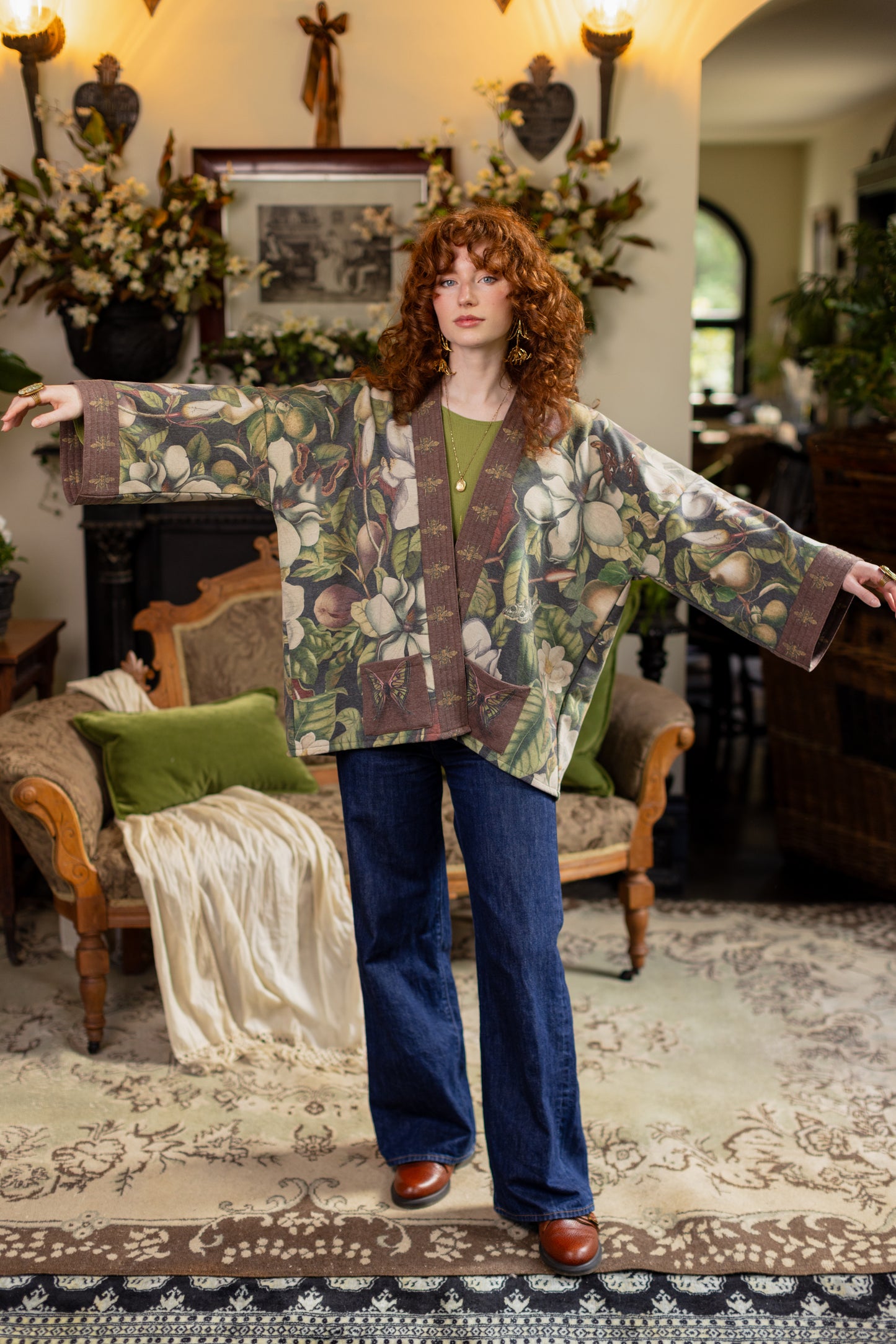 Model wearing a cozy cardigan lined with fleece featuring vintage magnolia lithographs, delicate moth etchings, and charming bumblebee trim - Market of stars