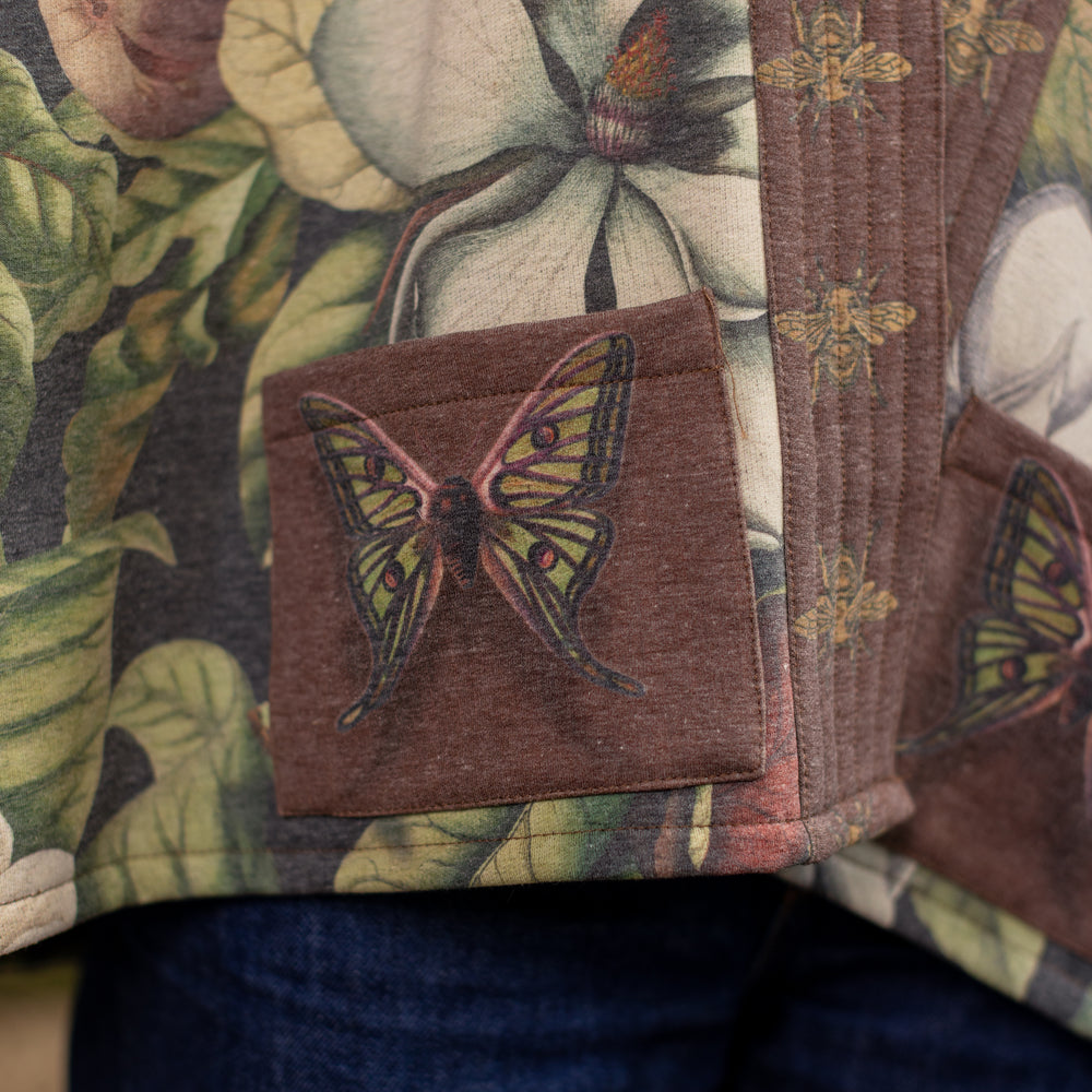 
                  
                    Model wearing a cozy cardigan lined with fleece featuring vintage magnolia lithographs, delicate moth etchings, and charming bumblebee trim - Market of stars
                  
                