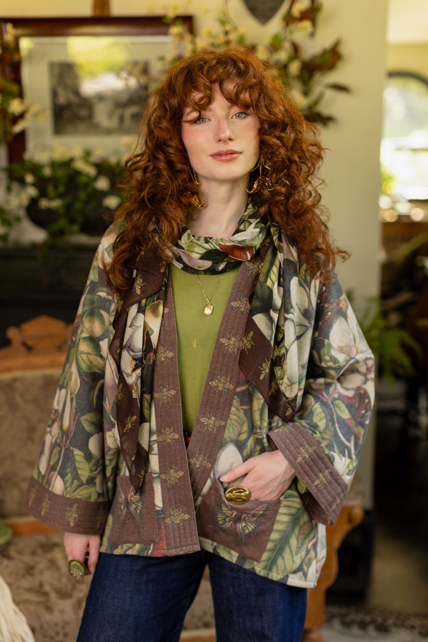 Model wearing a cozy cardigan lined with fleece featuring vintage magnolia lithographs, delicate moth etchings, and charming bumblebee trim - Market of stars
