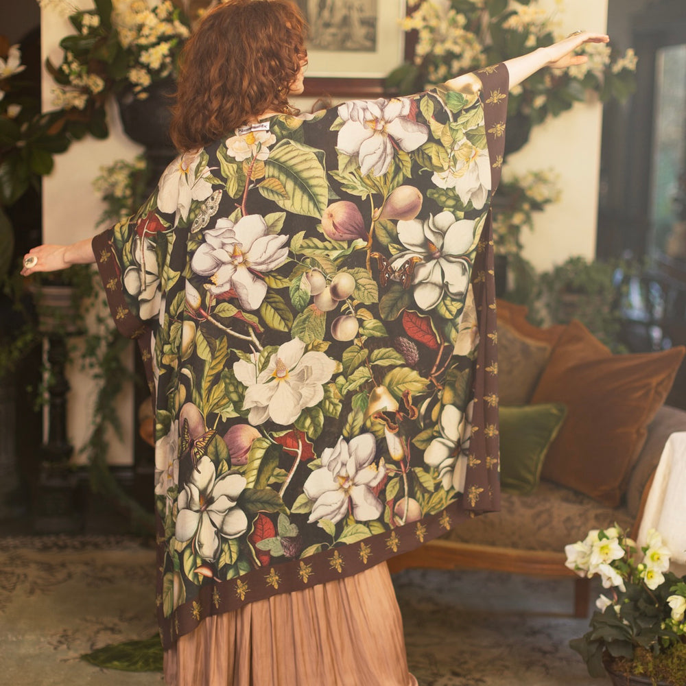 Model wearing a flowy kimono duster featuring vintage magnolia lithographs, delicate moth etchings, and charming bumblebee trim - Market of Stars