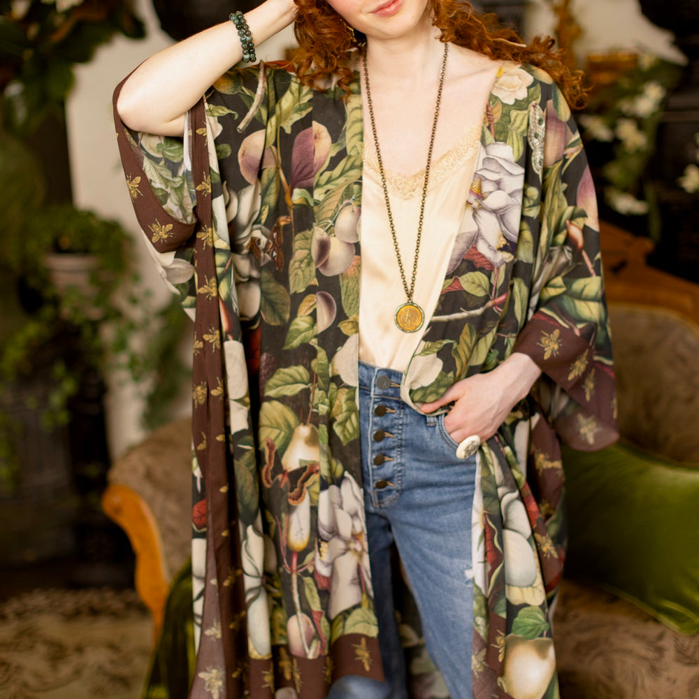 
                  
                    Model wearing a flowy kimono duster featuring vintage magnolia lithographs, delicate moth etchings, and charming bumblebee trim - Market of Stars
                  
                