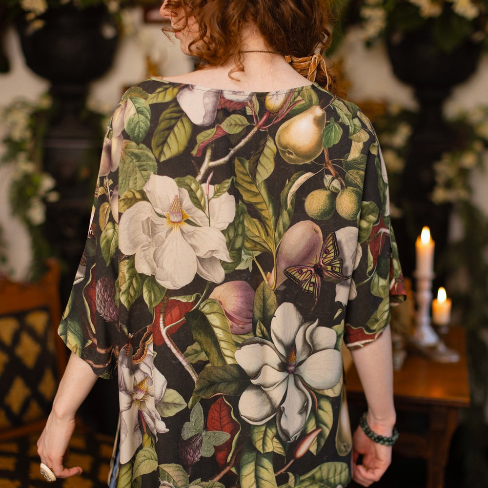
                  
                    Model wearing the Fleur De Lune Luxe Tee with wide scoop neck and soft bamboo-based viscose, featuring vintage magnolia lithographs, delicate moth etchings, and bumblebee trim - Market of Stars
                  
                