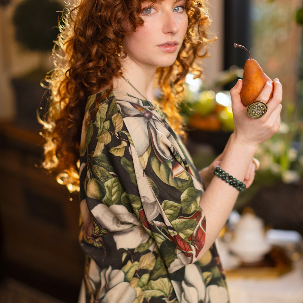 
                  
                    Model wearing the Fleur De Lune Luxe Tee with wide scoop neck and soft bamboo-based viscose, featuring vintage magnolia lithographs, delicate moth etchings, and bumblebee trim - Market of Stars
                  
                