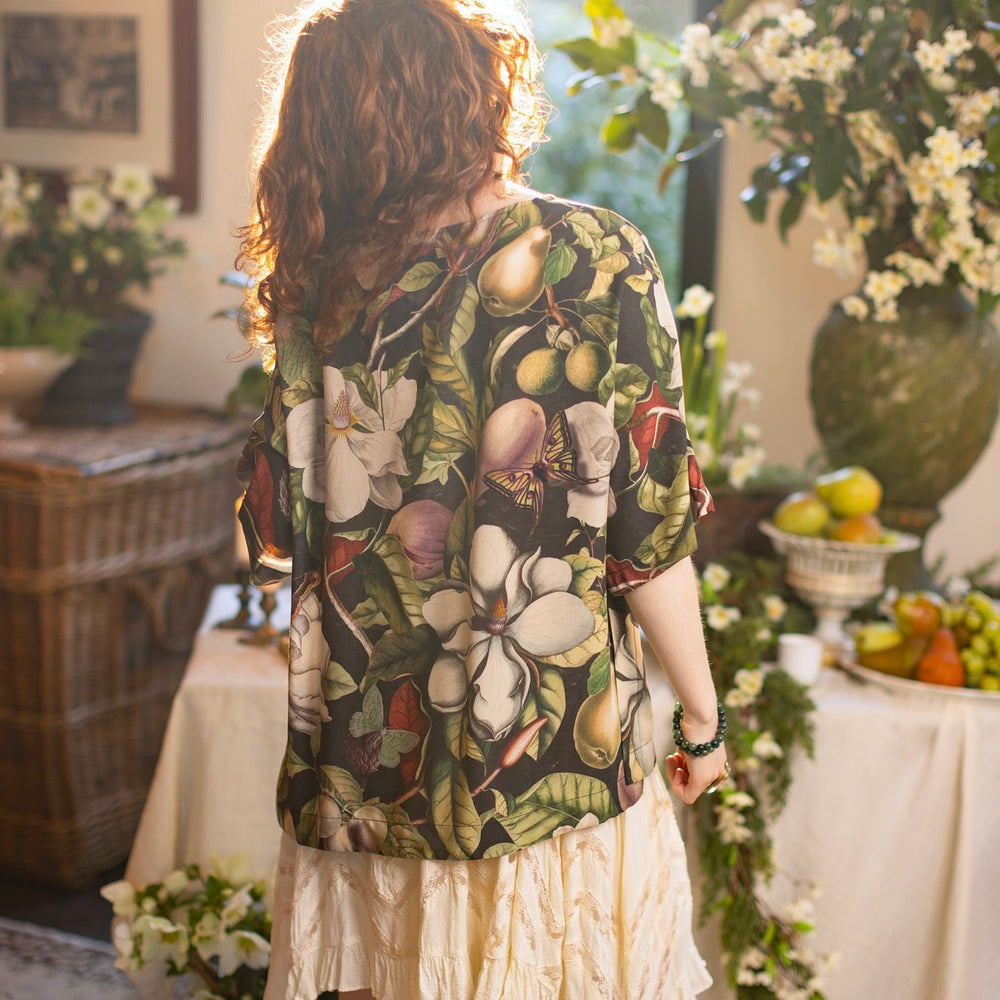 
                  
                    Model wearing the Fleur De Lune Luxe Tee with wide scoop neck and soft bamboo-based viscose, featuring vintage magnolia lithographs, delicate moth etchings, and bumblebee trim - Market of Stars
                  
                