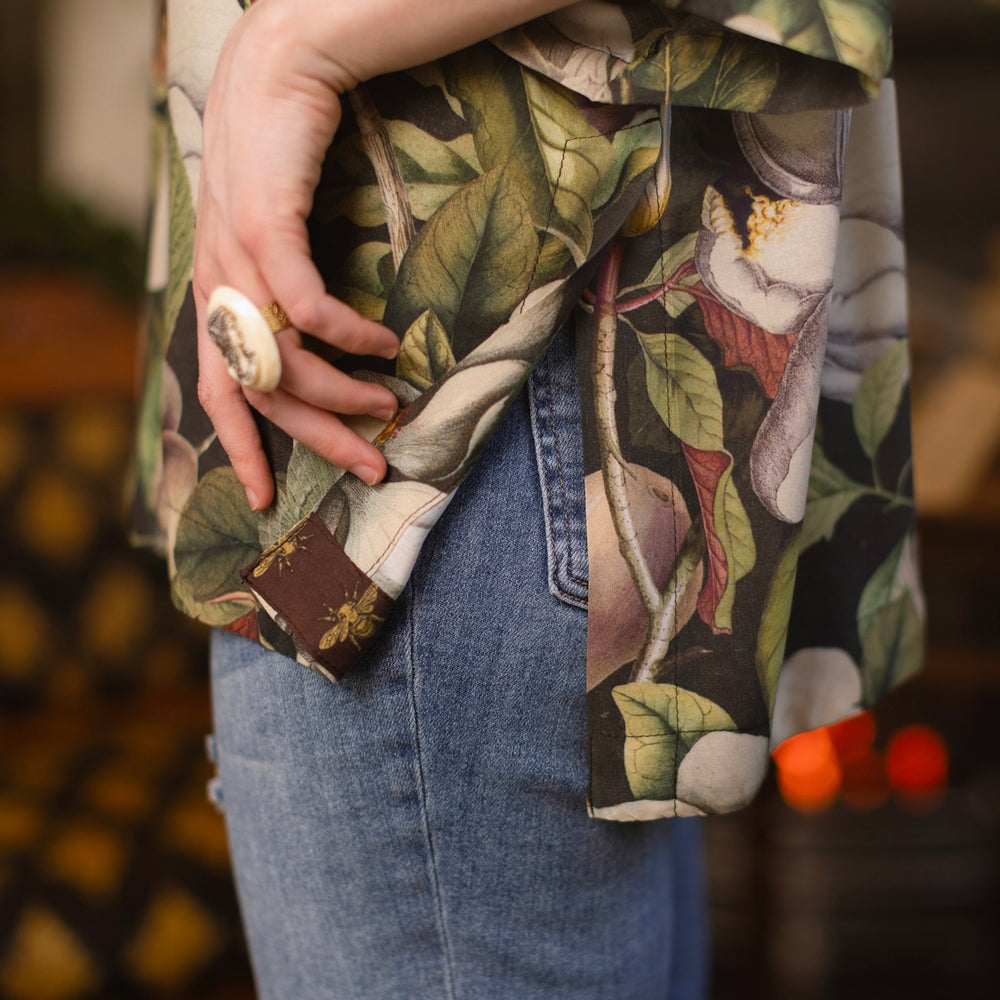 
                  
                    Model wearing the Fleur De Lune Luxe Tee with wide scoop neck and soft bamboo-based viscose, featuring vintage magnolia lithographs, delicate moth etchings, and bumblebee trim - Market of Stars
                  
                