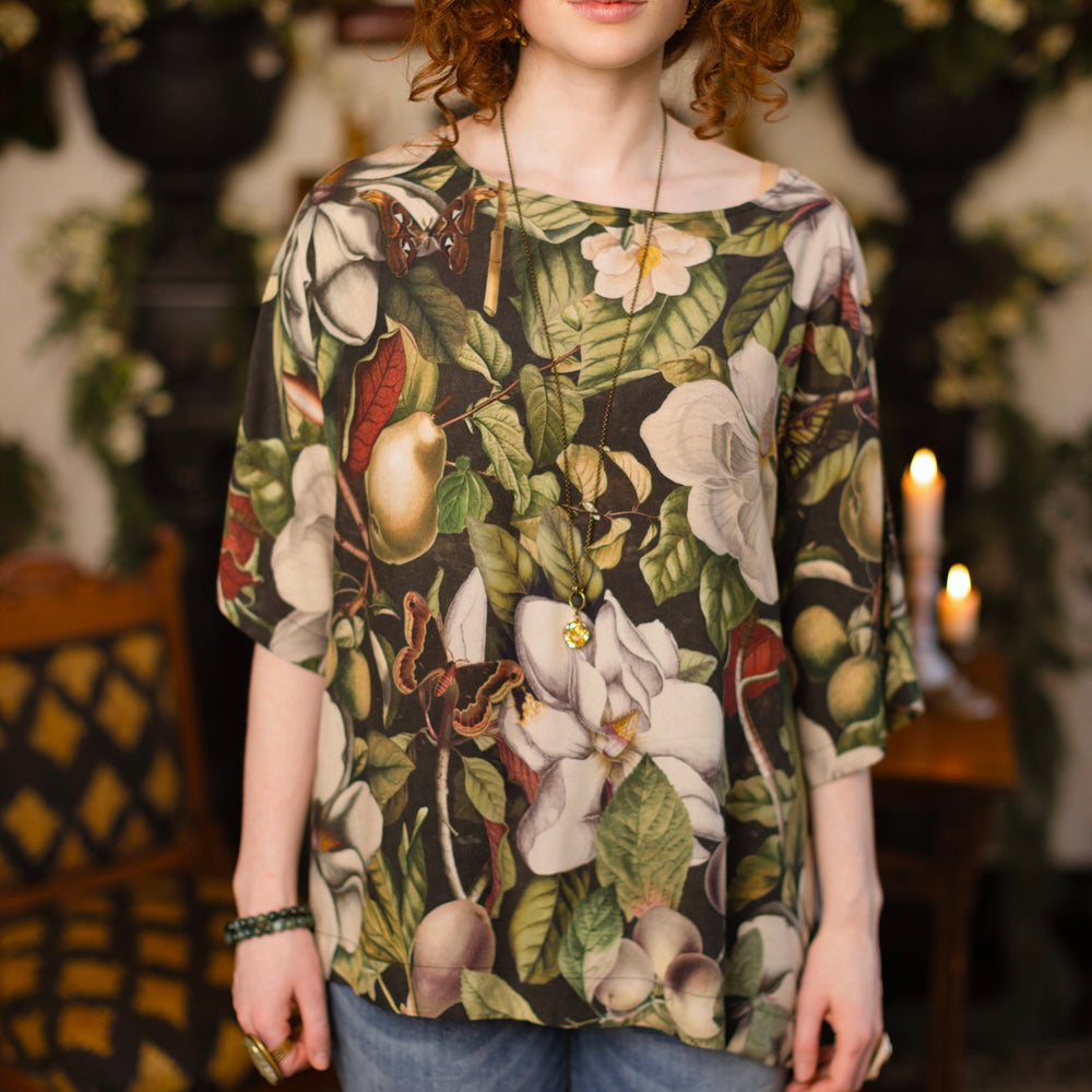 
                  
                    Model wearing the Fleur De Lune Luxe Tee with wide scoop neck and soft bamboo-based viscose, featuring vintage magnolia lithographs, delicate moth etchings, and bumblebee trim - Market of Stars
                  
                