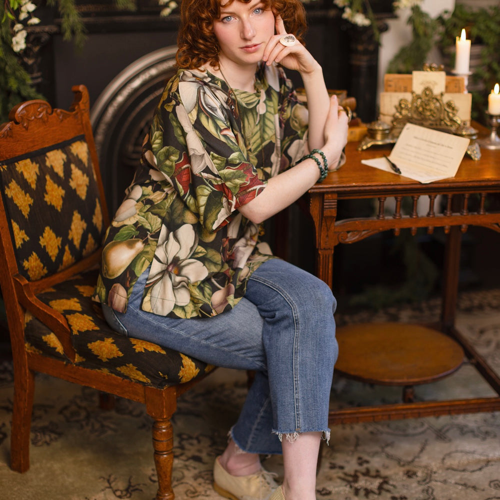
                  
                    Model wearing the Fleur De Lune Luxe Tee with wide scoop neck and soft bamboo-based viscose, featuring vintage magnolia lithographs, delicate moth etchings, and bumblebee trim - Market of Stars
                  
                