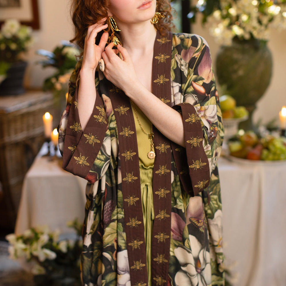 
                  
                    Model wearing a full length kimono duster robe featuring vintage magnolia lithographs, delicate moth etchings, and charming bumblebee trim - Market of Stars
                  
                