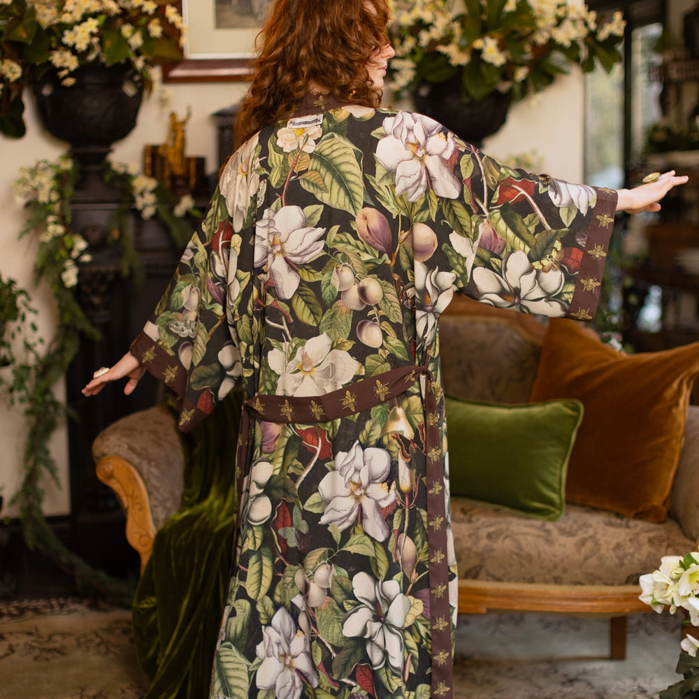 
                  
                    Model wearing a full length kimono duster robe featuring vintage magnolia lithographs, delicate moth etchings, and charming bumblebee trim - Market of Stars
                  
                