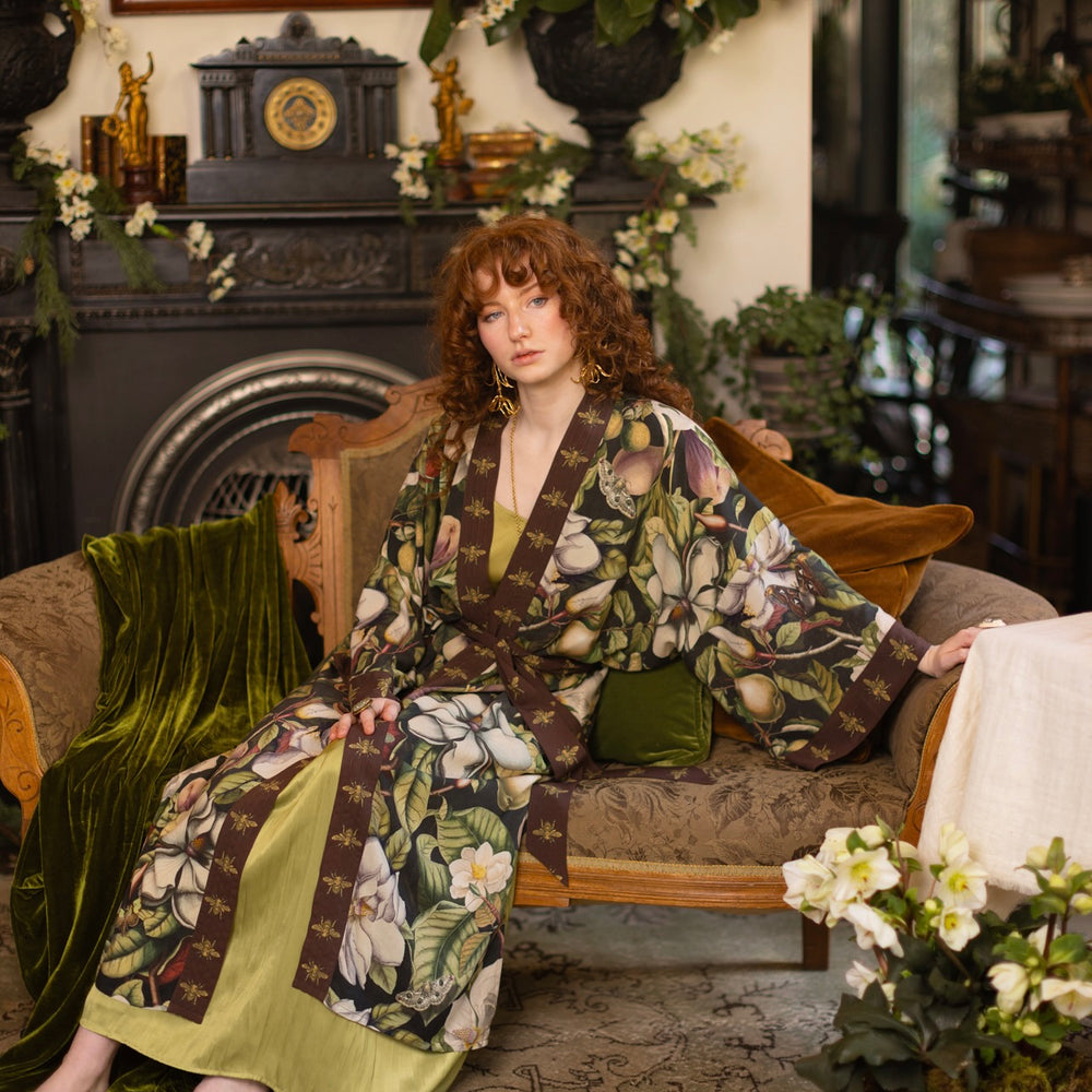
                  
                    Model wearing a full length kimono duster robe featuring vintage magnolia lithographs, delicate moth etchings, and charming bumblebee trim - Market of Stars
                  
                