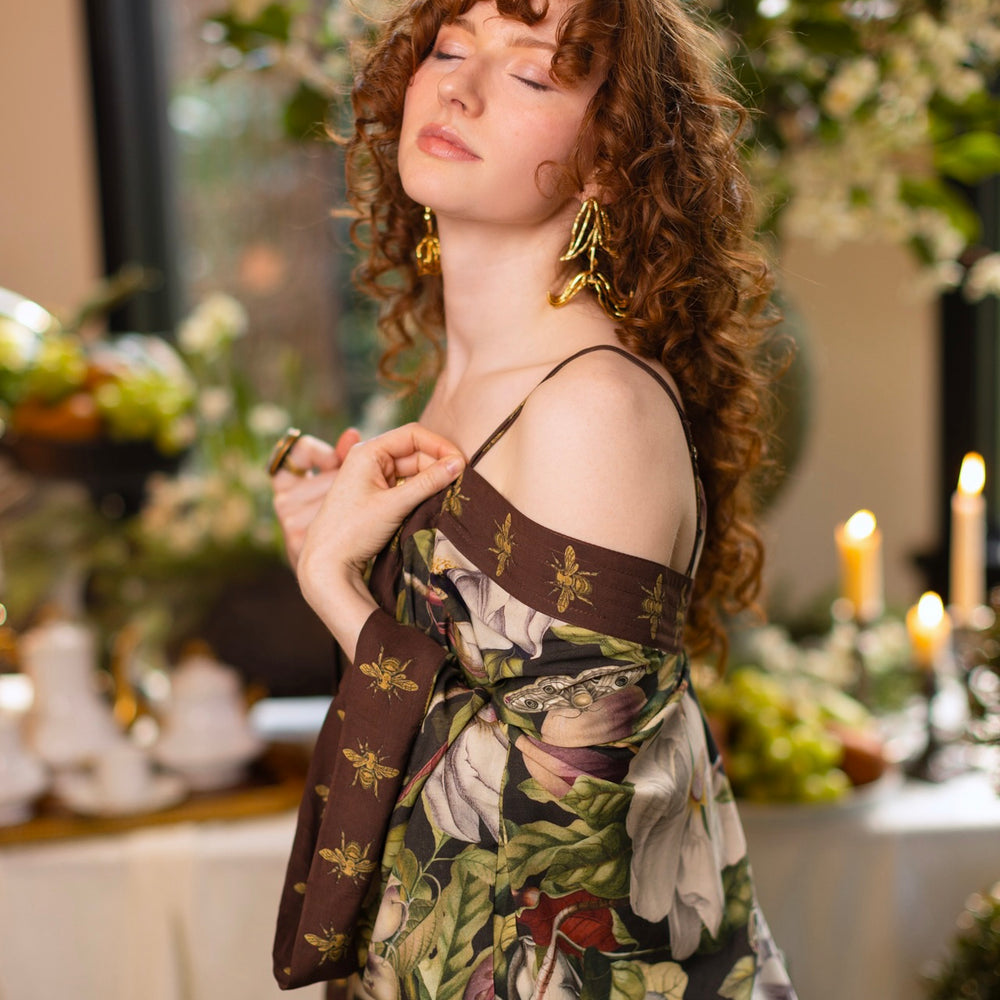 
                  
                    Model wearing a full length kimono duster robe featuring vintage magnolia lithographs, delicate moth etchings, and charming bumblebee trim - Market of Stars
                  
                