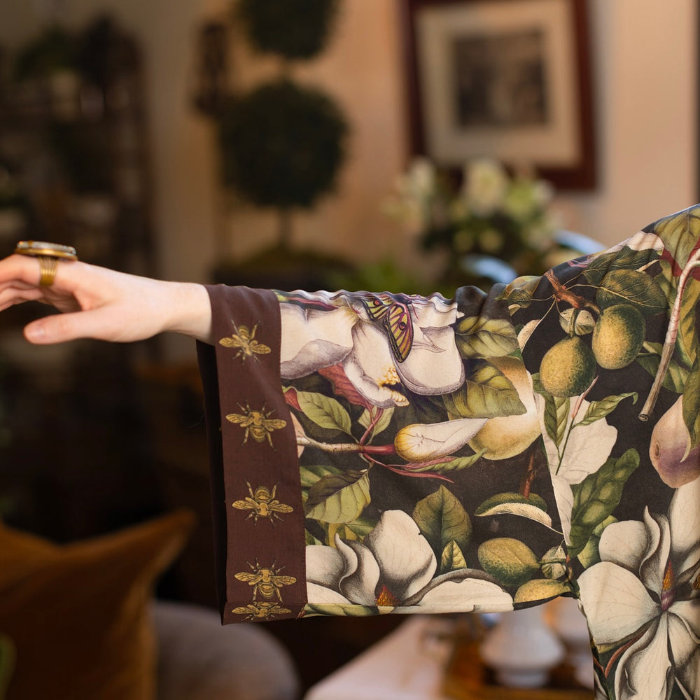 
                  
                    Model wearing a full length kimono duster robe featuring vintage magnolia lithographs, delicate moth etchings, and charming bumblebee trim - Market of Stars
                  
                