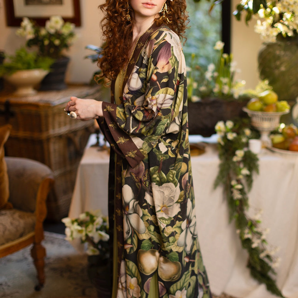 
                  
                    Model wearing a full length kimono duster robe featuring vintage magnolia lithographs, delicate moth etchings, and charming bumblebee trim - Market of Stars
                  
                