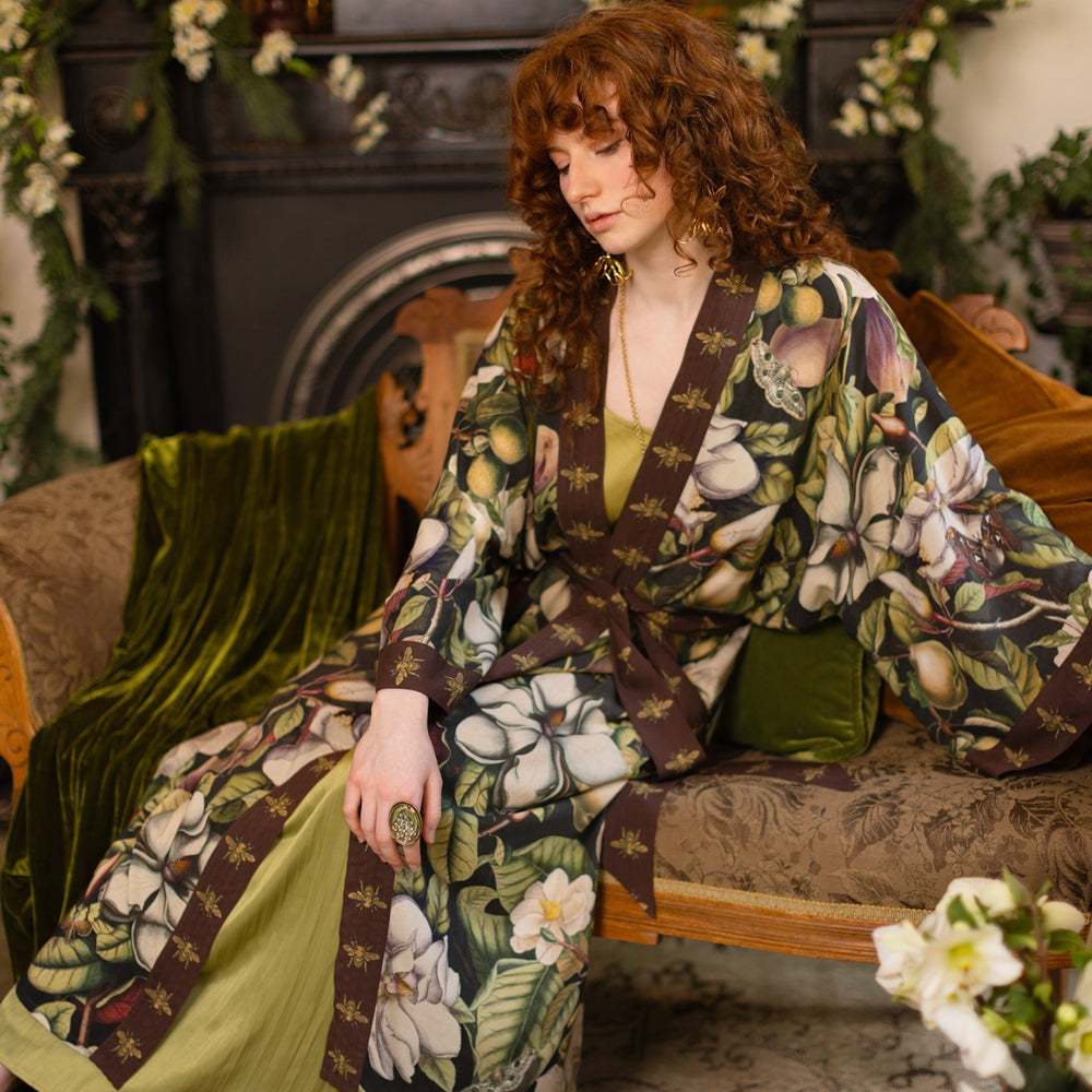 
                  
                    Model wearing a full length kimono duster robe featuring vintage magnolia lithographs, delicate moth etchings, and charming bumblebee trim - Market of Stars
                  
                