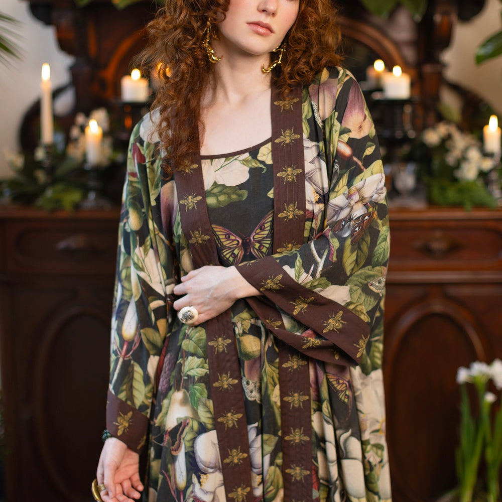 
                  
                    Model wearing a full length kimono duster robe featuring vintage magnolia lithographs, delicate moth etchings, and charming bumblebee trim - Market of Stars
                  
                