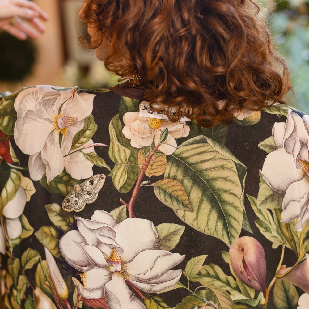 
                  
                    Model wearing a full length kimono duster robe featuring vintage magnolia lithographs, delicate moth etchings, and charming bumblebee trim - Market of Stars
                  
                