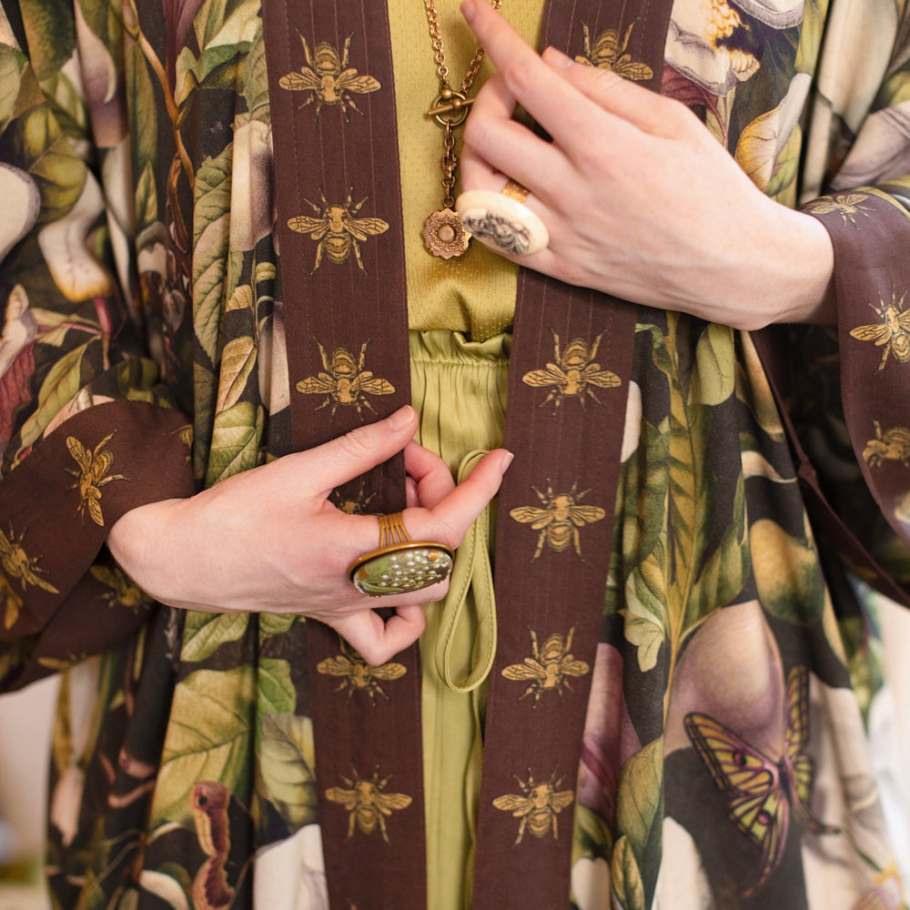 
                  
                    Model wearing a full length kimono duster robe featuring vintage magnolia lithographs, delicate moth etchings, and charming bumblebee trim - Market of Stars
                  
                