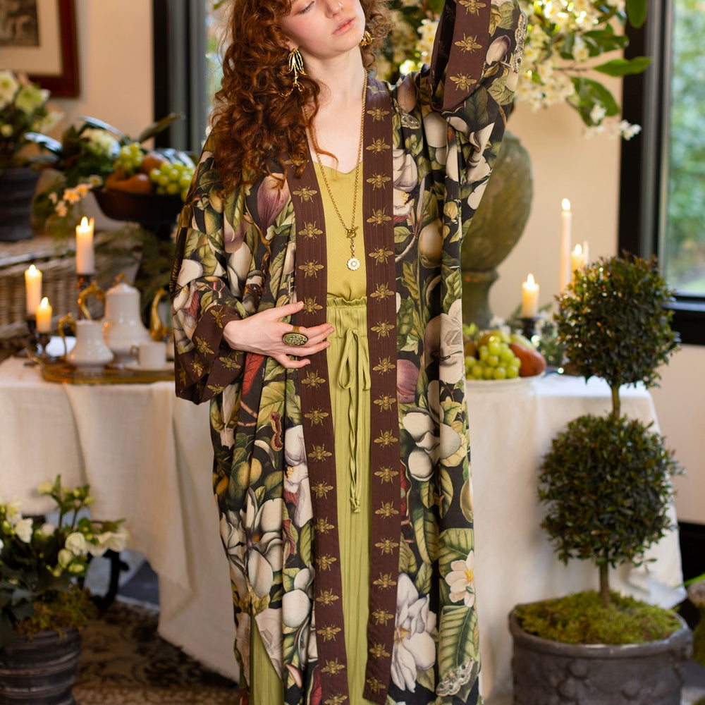 
                  
                    Model wearing a full length kimono duster robe featuring vintage magnolia lithographs, delicate moth etchings, and charming bumblebee trim - Market of Stars
                  
                
