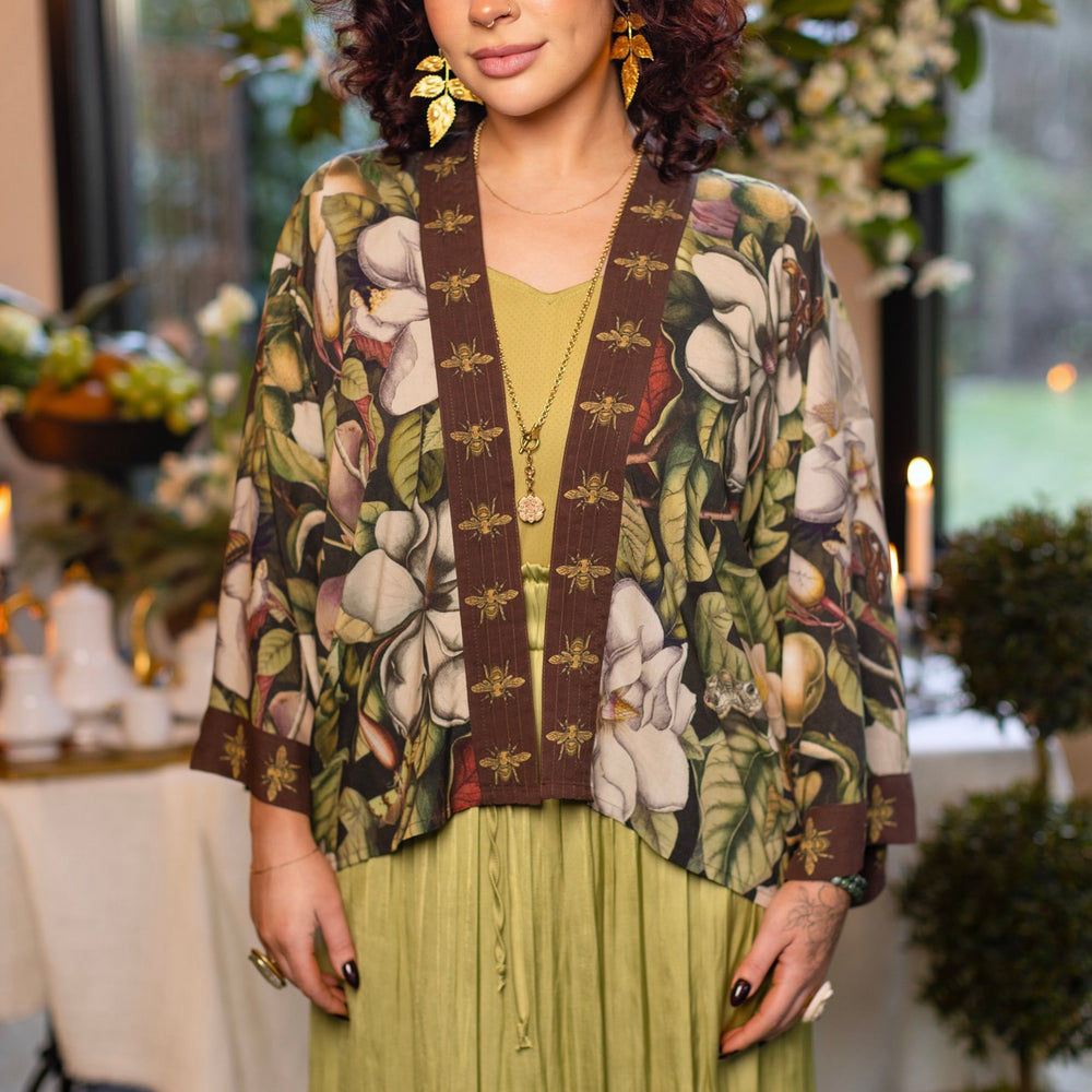 Model wearing a cropped kimono duster featuring vintage magnolia lithographs, delicate moth etchings, and charming bumblebee trim - Market of Stars