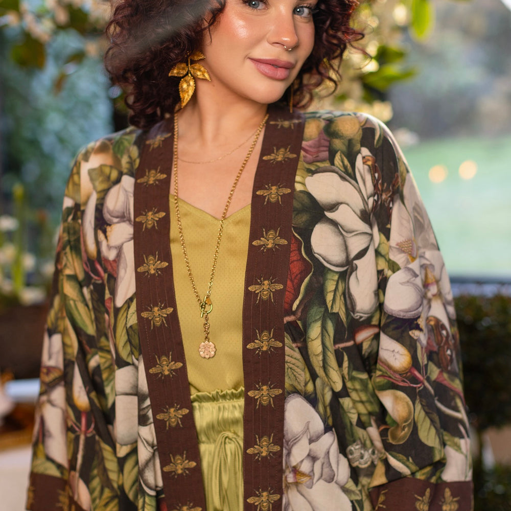 
                  
                    Model wearing a cropped kimono duster featuring vintage magnolia lithographs, delicate moth etchings, and charming bumblebee trim - Market of Stars
                  
                