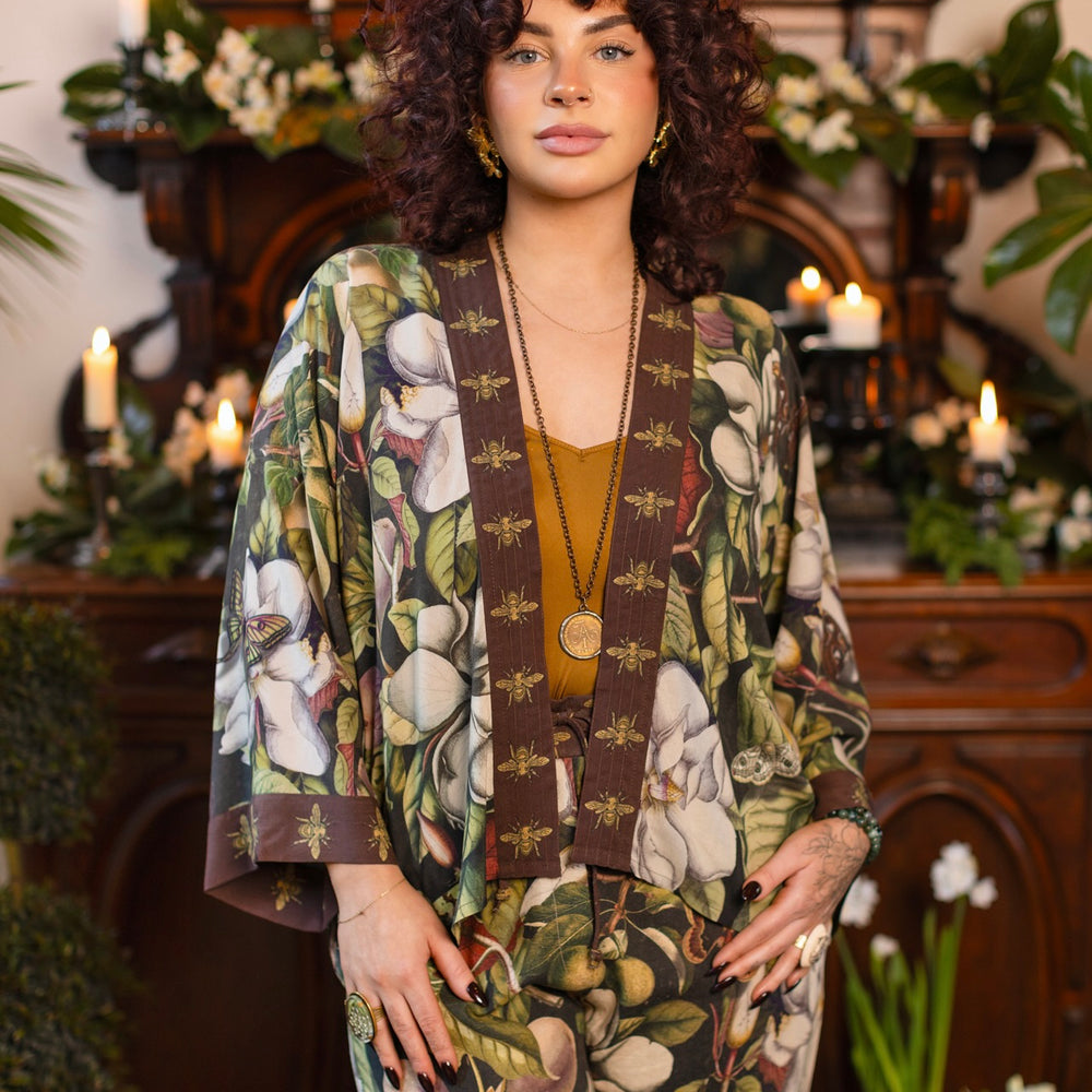 
                  
                    Model wearing a cropped kimono duster featuring vintage magnolia lithographs, delicate moth etchings, and charming bumblebee trim - Market of Stars
                  
                
