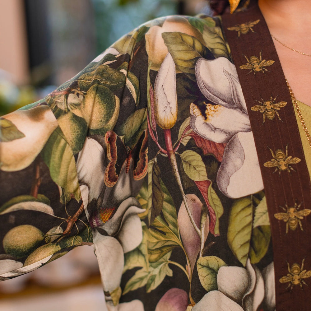 
                  
                    Model wearing a cropped kimono duster featuring vintage magnolia lithographs, delicate moth etchings, and charming bumblebee trim - Market of Stars
                  
                