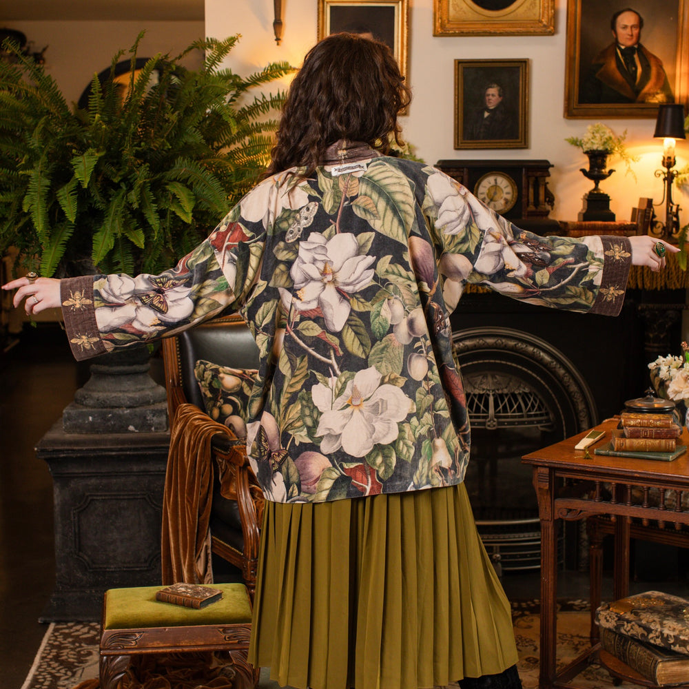 
                  
                    Model wearing a soft cotton velvet duster ft. vintage lithographs of magnolias & 1800's etchings of moths and pears - Market of Stars
                  
                