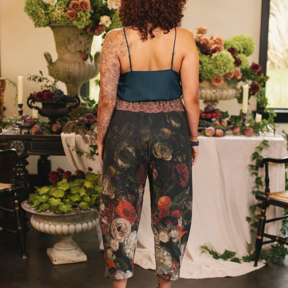 
                  
                    Model wearing the Folklore Artist Pant featuring the Bird-of-Peace embroidery and unfinished William Morris textile designs—artful linen blend pants by Market of Stars.
                  
                