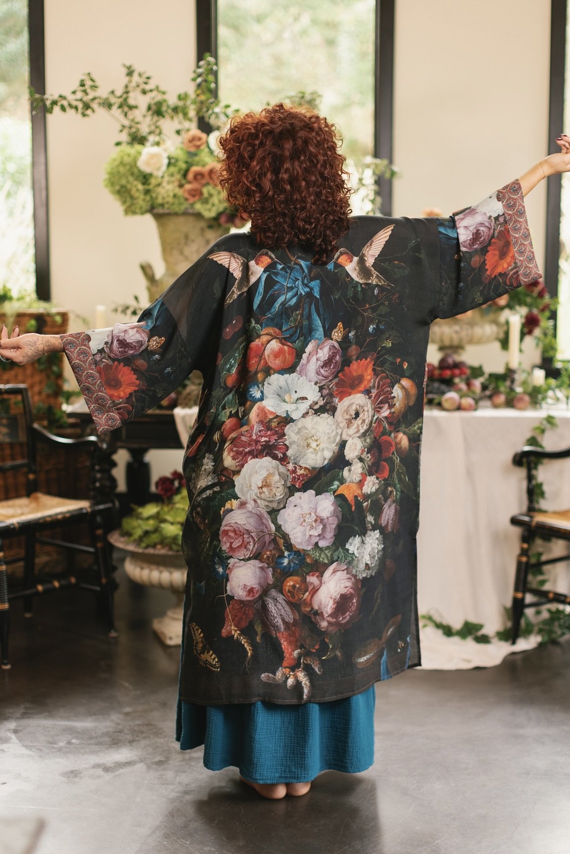 Model showcasing the Flight of Fancy Opera Robe featuring vibrant hummingbirds and historic floral paintings by Rachel Ruysch – Market of Stars.
