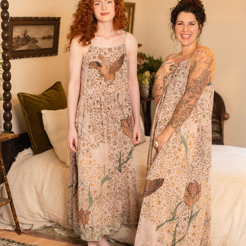 
                  
                    Model wearing Folklore Boheme slip dress featuring Bird-of-Peace embroidery and unfinished William Morris artwork in earthy romantic tones – Market of Stars.
                  
                