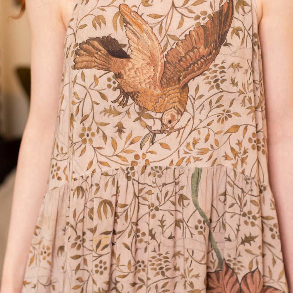 
                  
                    Model wearing Folklore Boheme slip dress featuring Bird-of-Peace embroidery and unfinished William Morris artwork in earthy romantic tones – Market of Stars.
                  
                