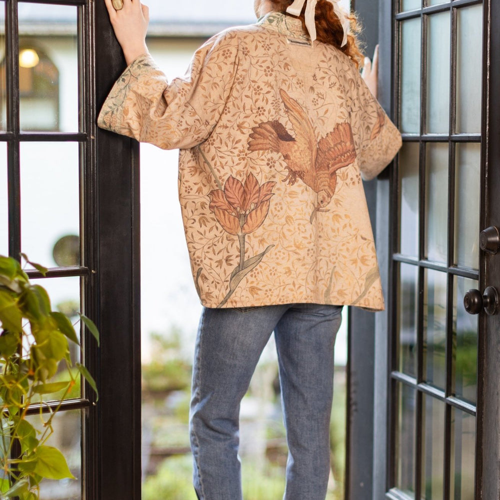Model in cozy Folklore cottage cardigan featuring Bird-of-Peace embroidery and unfinished William Morris textile art in soft earthy tones – Market of Stars.