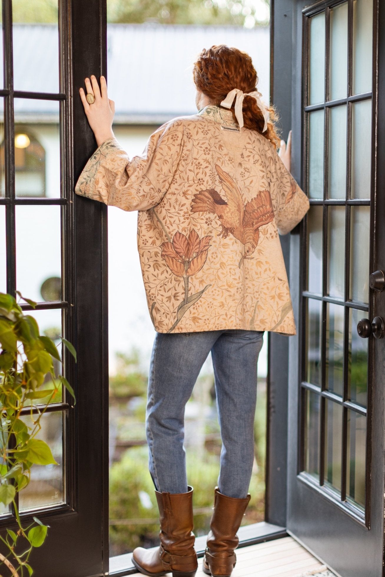 Model in cozy Folklore cottage cardigan featuring Bird-of-Peace embroidery and unfinished William Morris textile art in soft earthy tones – Market of Stars.