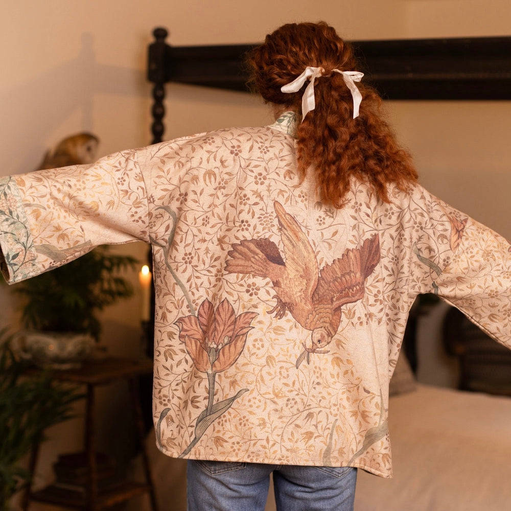 
                  
                    Model in cozy Folklore cottage cardigan featuring Bird-of-Peace embroidery and unfinished William Morris textile art in soft earthy tones – Market of Stars.
                  
                
