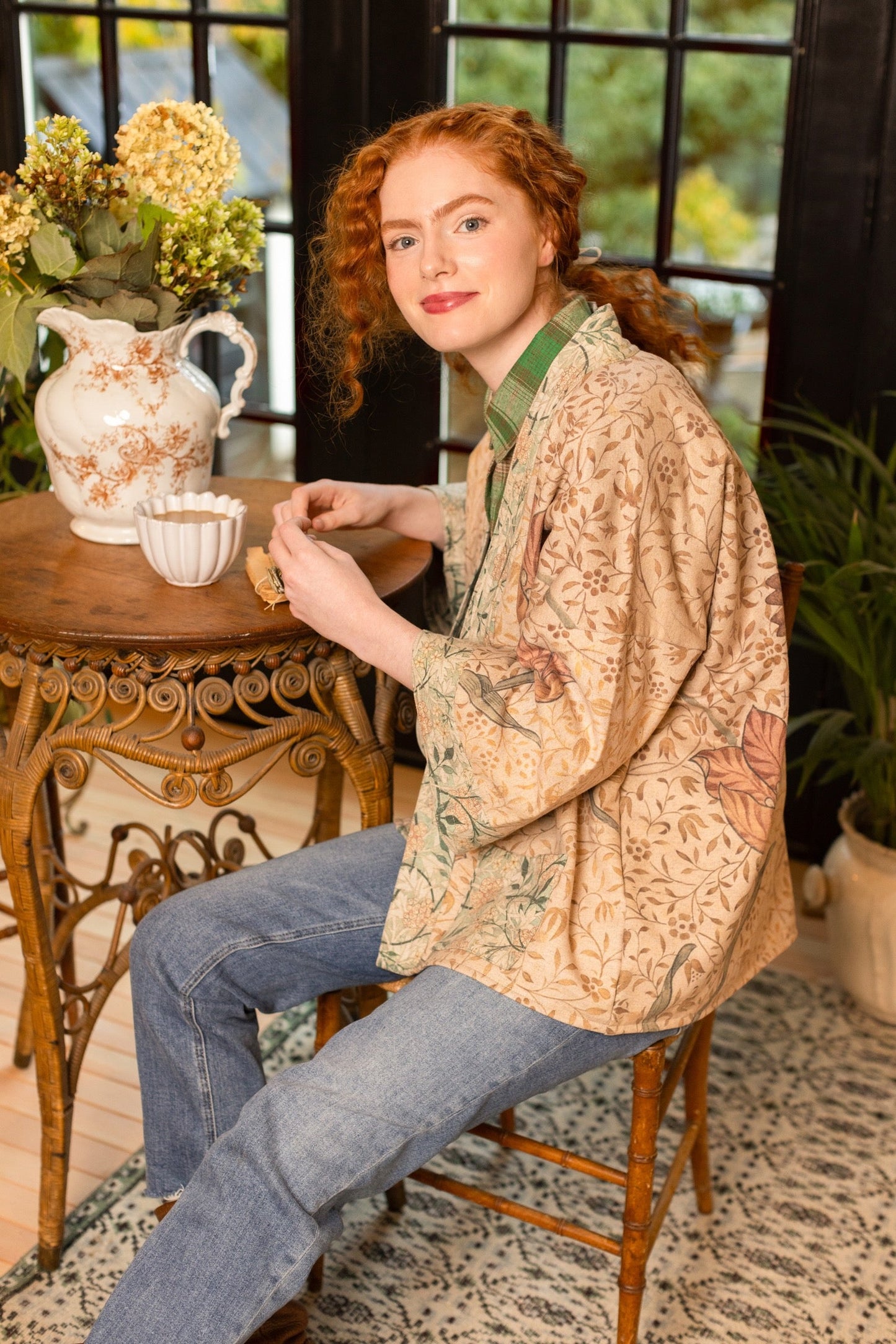 Model in cozy Folklore cottage cardigan featuring Bird-of-Peace embroidery and unfinished William Morris textile art in soft earthy tones – Market of Stars.
