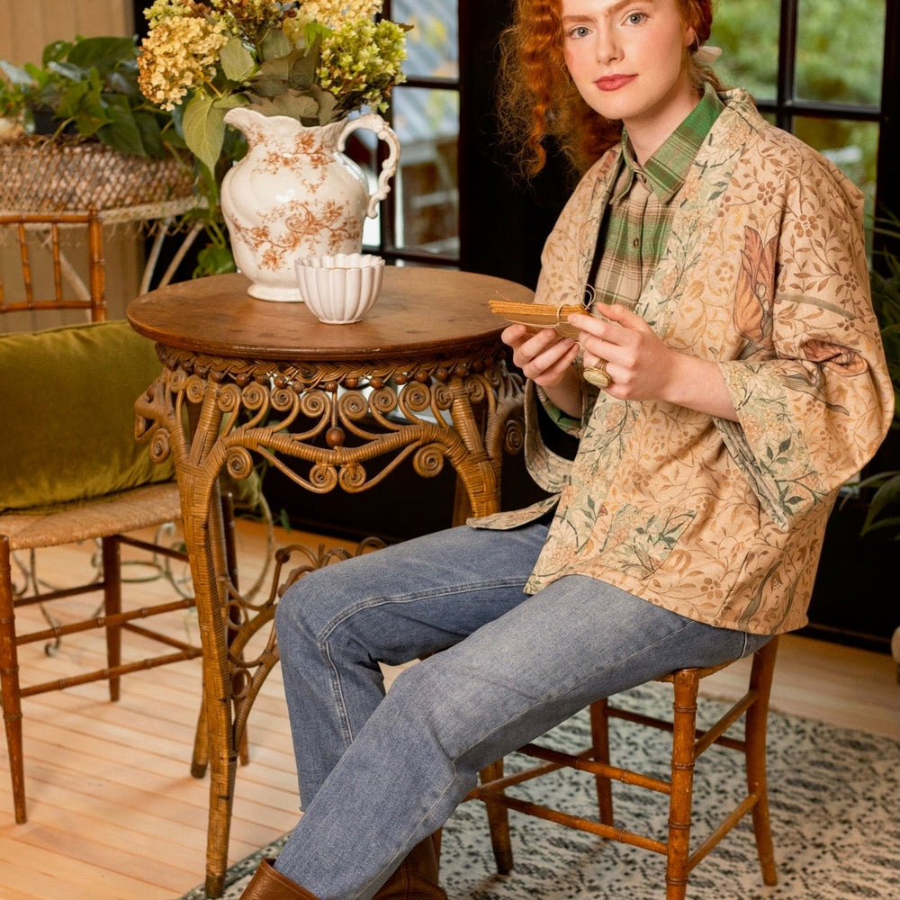 
                  
                    Model in cozy Folklore cottage cardigan featuring Bird-of-Peace embroidery and unfinished William Morris textile art in soft earthy tones – Market of Stars.
                  
                