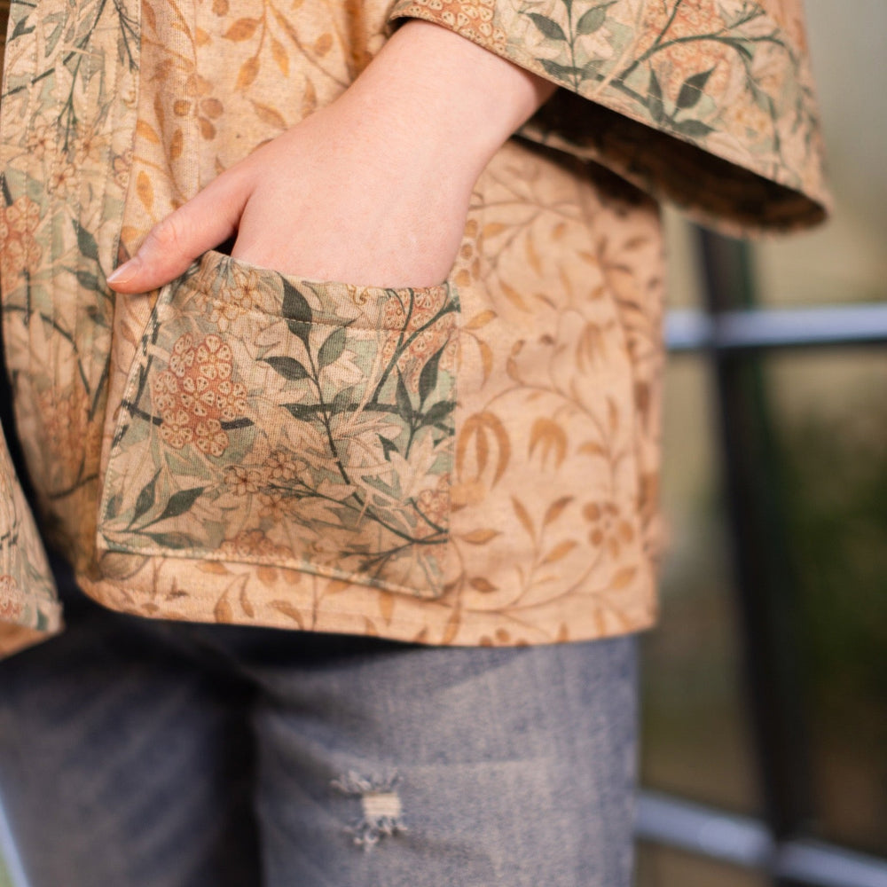 
                  
                    Model in cozy Folklore cottage cardigan featuring Bird-of-Peace embroidery and unfinished William Morris textile art in soft earthy tones – Market of Stars.
                  
                